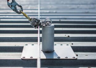 Industrial rooftop fall protection system with anchors, guardrails, and ladder access in Ontario commercial facility