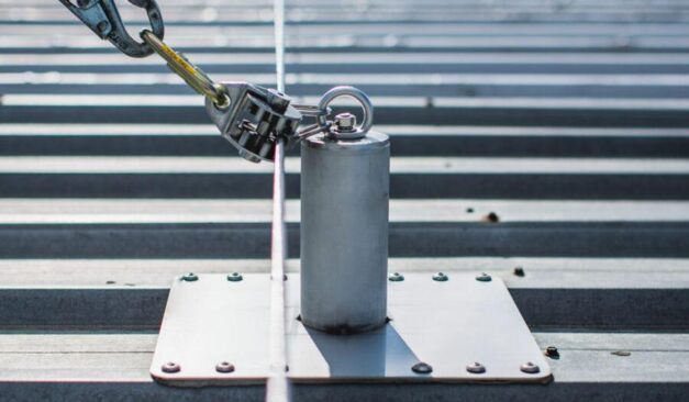 Industrial rooftop fall protection system with anchors, guardrails, and ladder access in Ontario commercial facility